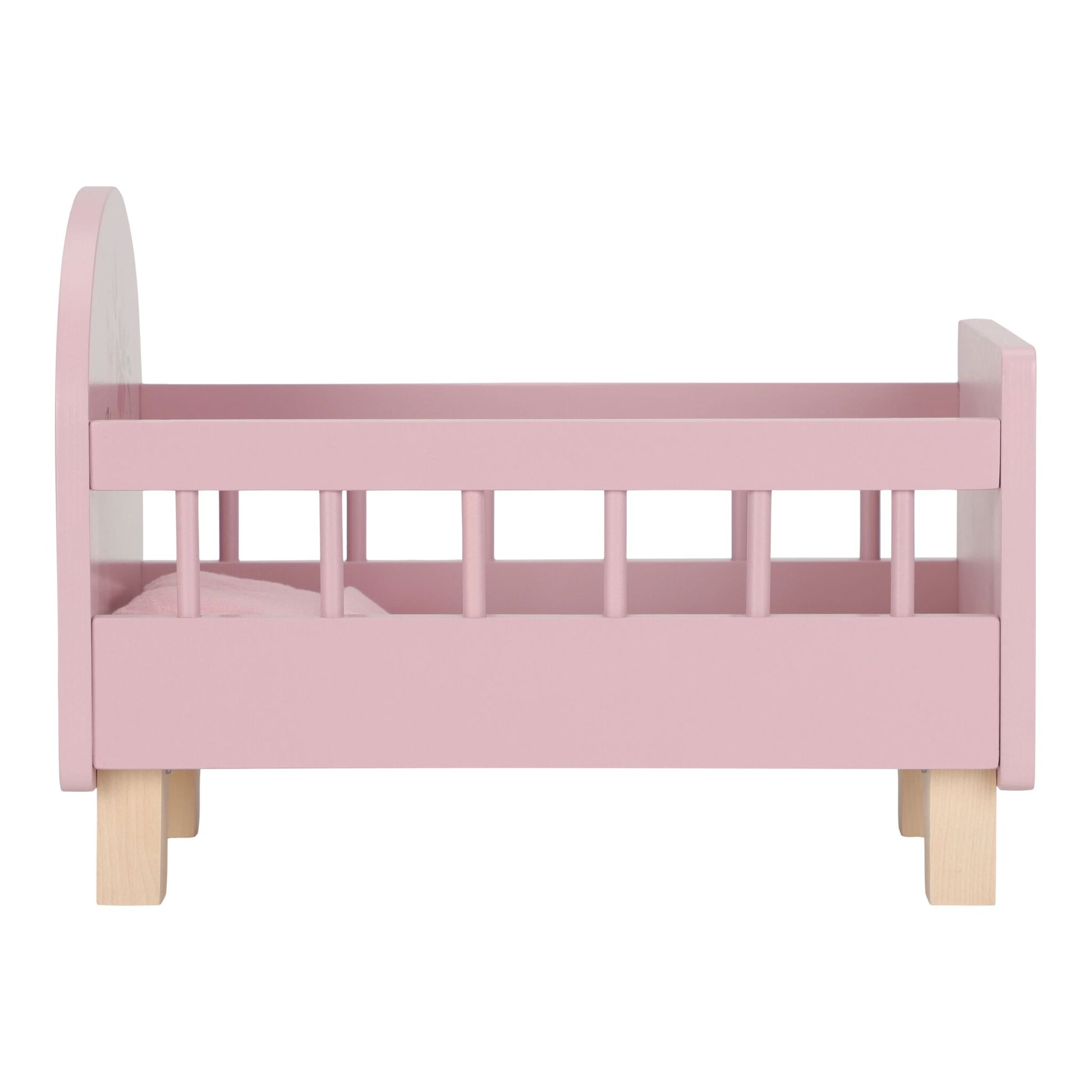 Pink doll bed with wooden legs on a white background