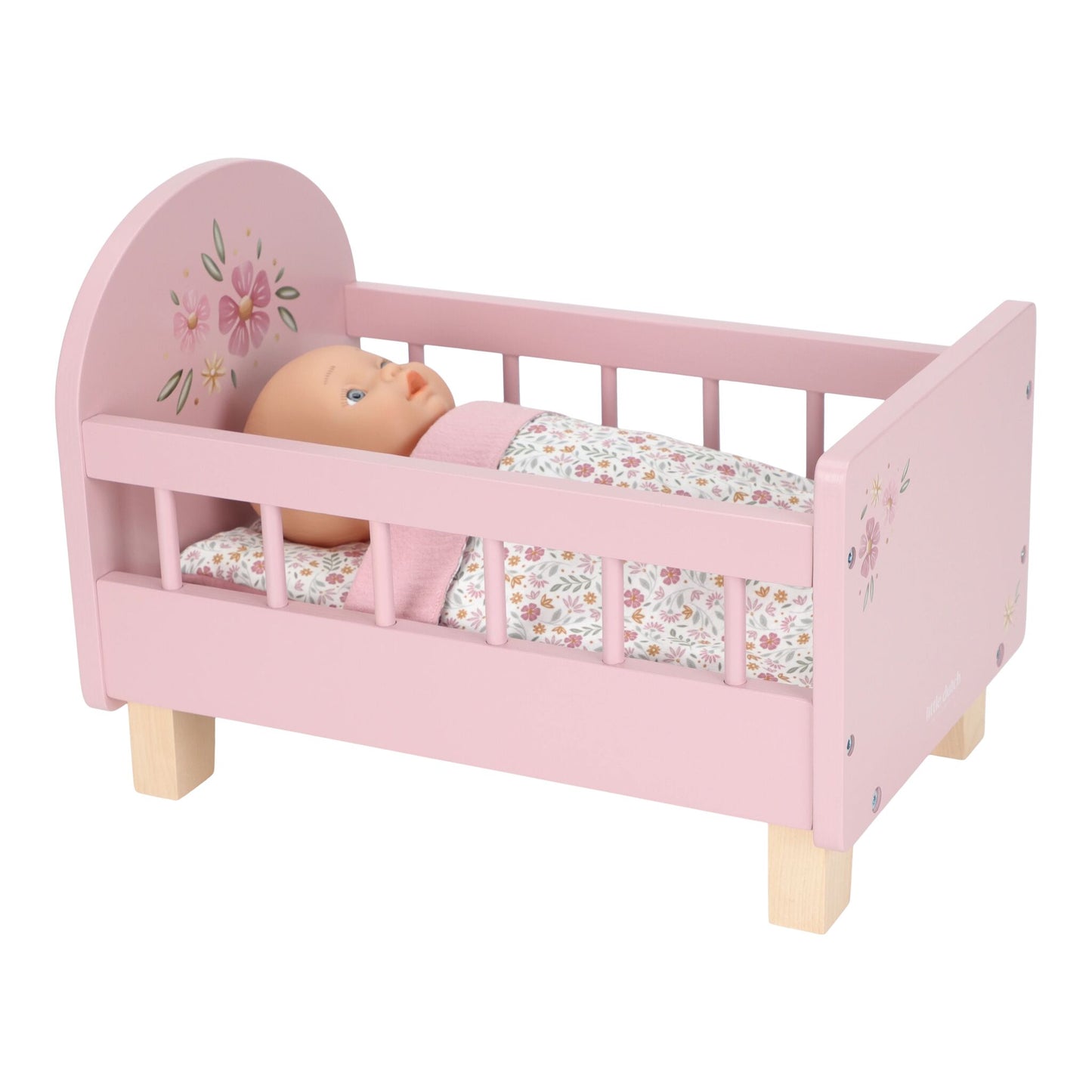 Pink doll bed with a baby doll on a white background