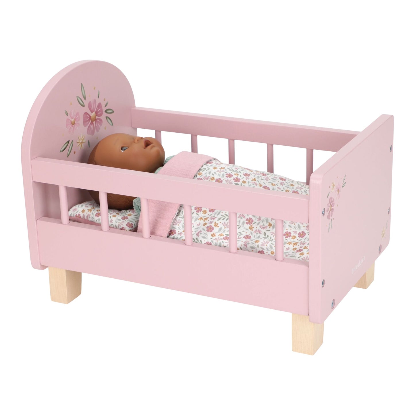 Pink doll bed with a floral pattern and a doll inside on a white background
