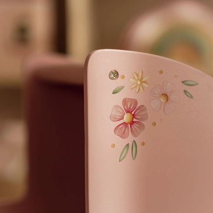 Pink Doll Pram with floral designs on a blurred background