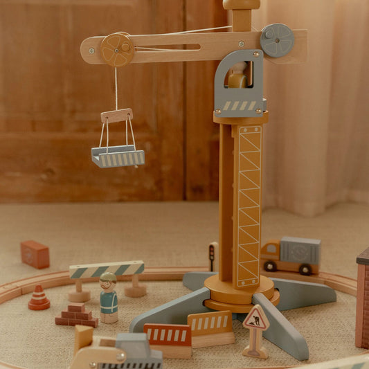 Wooden toy crane set against a wooden background